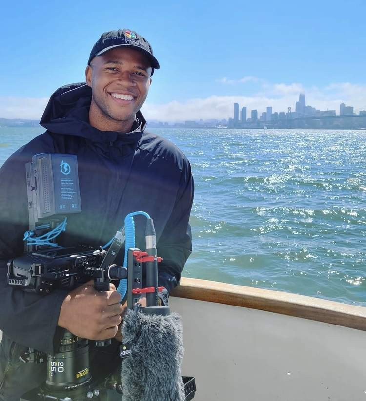 Aaron on a boat on San Francisco Bay holding a rigged cinema camera