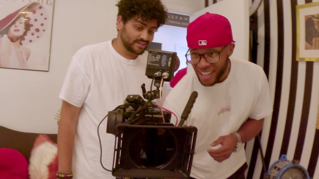 Two of the APEX crew laughing over the cinema camera