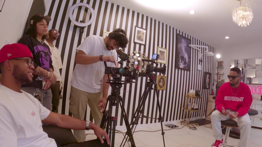 A two-camera interview setup in the striped room