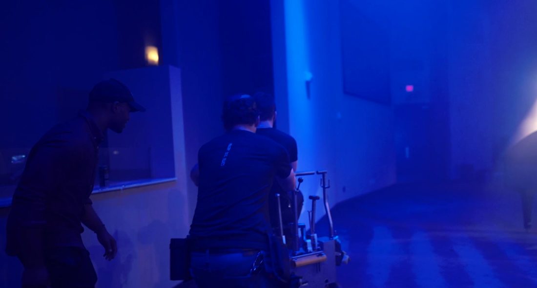 The crew in blue light on Let Go, Let God
