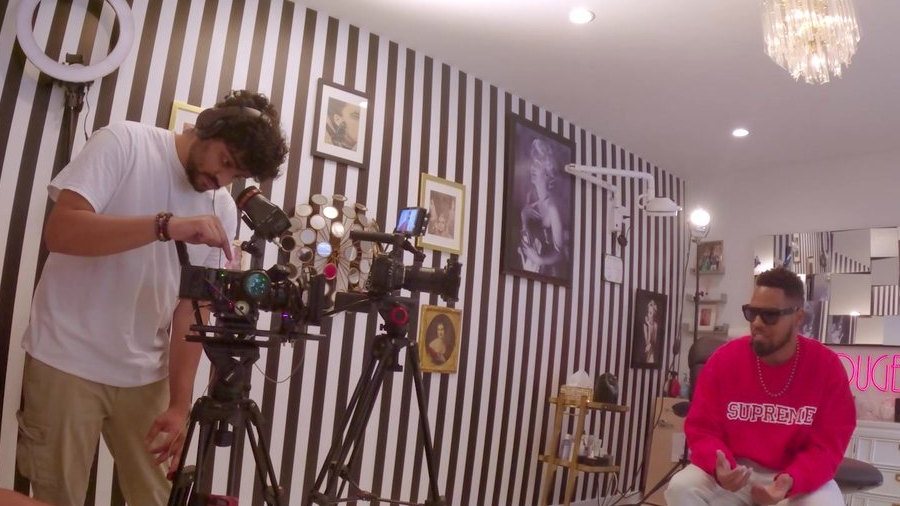 An APEX camera operator setting two cinema cameras for an interview on the Beyond Beauty set